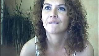Beautiful curly brunette demonstrating her arsenal of toys