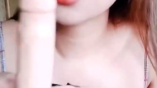 Hot asian Try to put condom using her mouth on her Strap-on