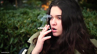 Young Brunette Is Taking an Unhurried Stroll with Allwhite 120mm Cigarette
