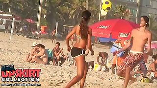 The turning on brunette on the beach is wearing the sport