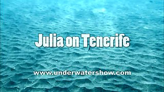 Julia is swimming underwater nude in the sea