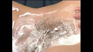 Redhead shaves her pussy and fingers it