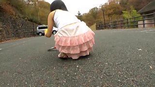 Asian teen bends over and shows horny upskirt in the street