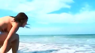 Horny brunette babe flashing a hairy pussy on the beach