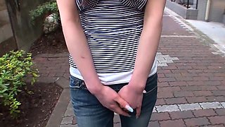 Asian cutie in high heels keeps a toy in her jeans