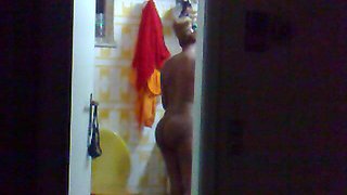 Hidden surveillance in the bathroom of an ebony woman with a nice body