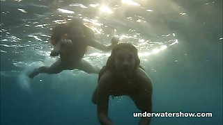 Julia and Masha are swimming nude in the sea