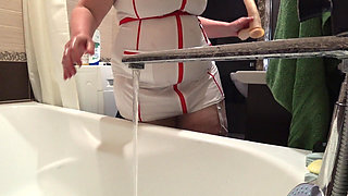 Big Boobs. Gorgeous Cleavage Under a Medical Gown. a Mature Nurse on Camera at Work