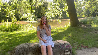 Innocent Girl Sits in the Park and Eats Lollipop Not Knowing That Her Panties Can Be Seen