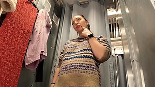 I try on clothes in fitting room with open curtain.