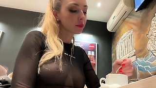 Flashing her big boobs in transparent top in public cafe.