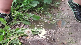 A unshaved muff pisses outdoors in public places. Lots of urine from a bodacious COUGAR with a phat bum. Amateur fetish.