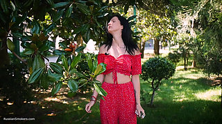 Sultry Brunette in Red Dress Smoking Rolled Cigarette