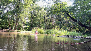 Cute Teen in Costume Playing in the River Like in a Swimming Pool