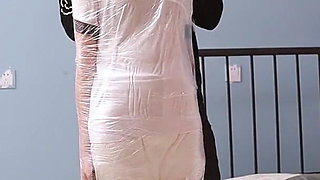 A Cute Barefoot Girlfriend Uses Tape to Bind Her Whole Body, Playing with Her Cute Bare Feet