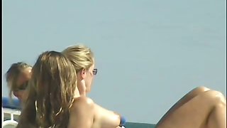 Sweet party chicks flashing their big tits on the beach