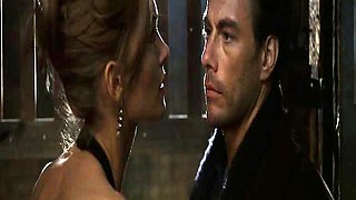 Natasha Henstridge making out with a guy in a bathroom as